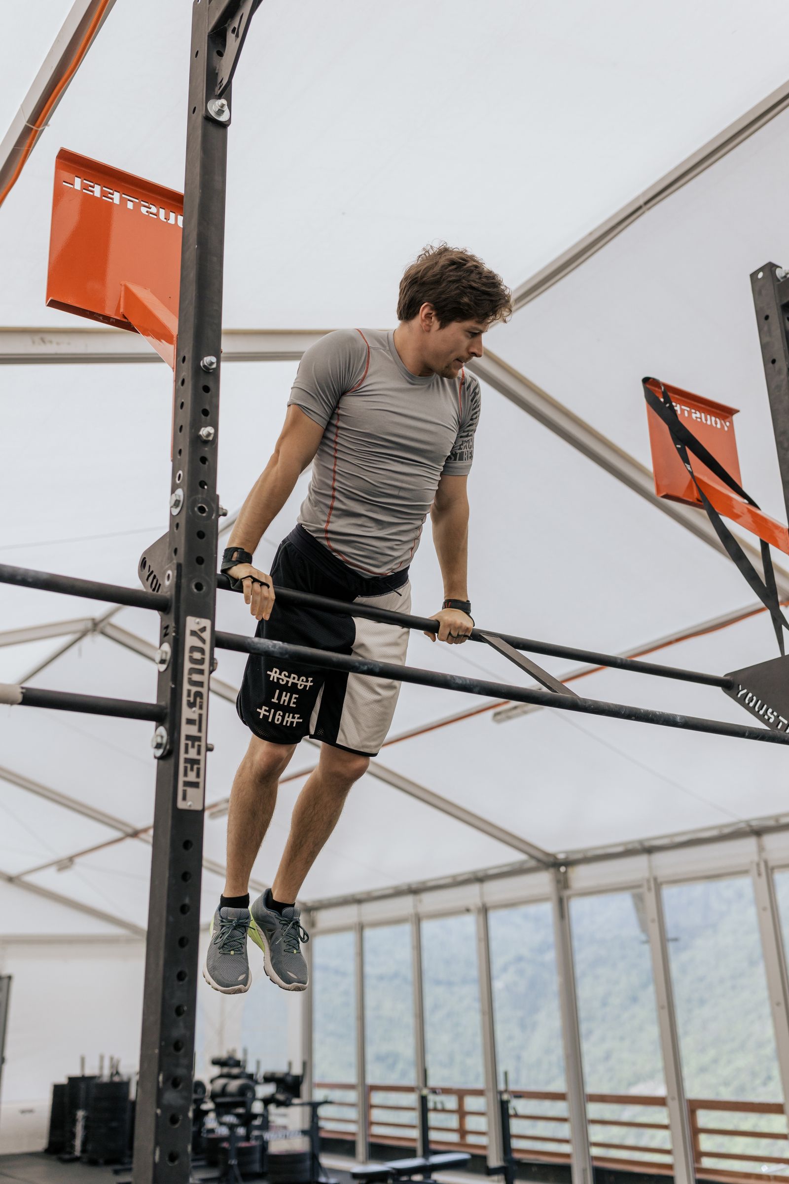 Stock photograph of an athlete on gym bars